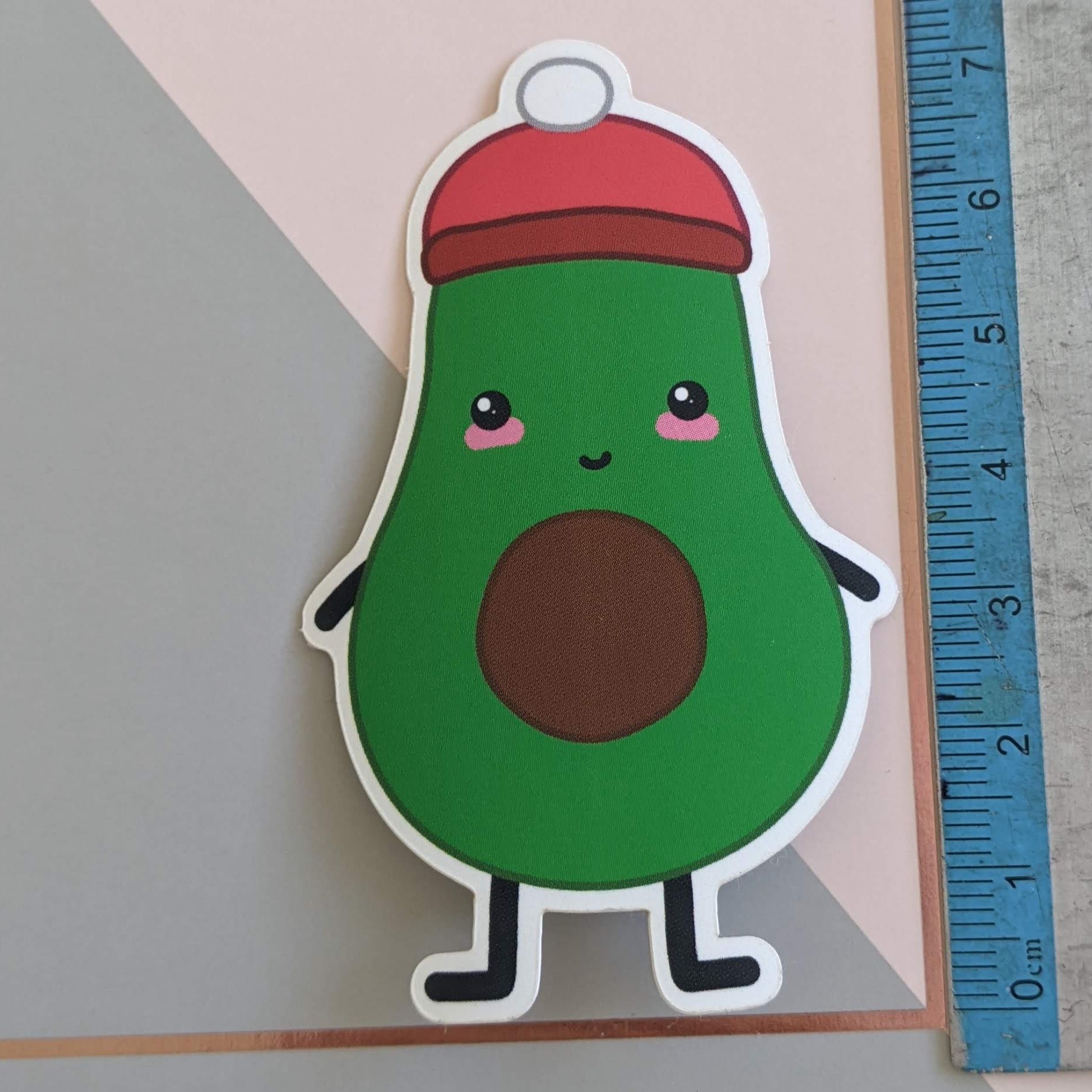 A close up of the avocado sticker with a ruler showing the scale of 7.25cm tall