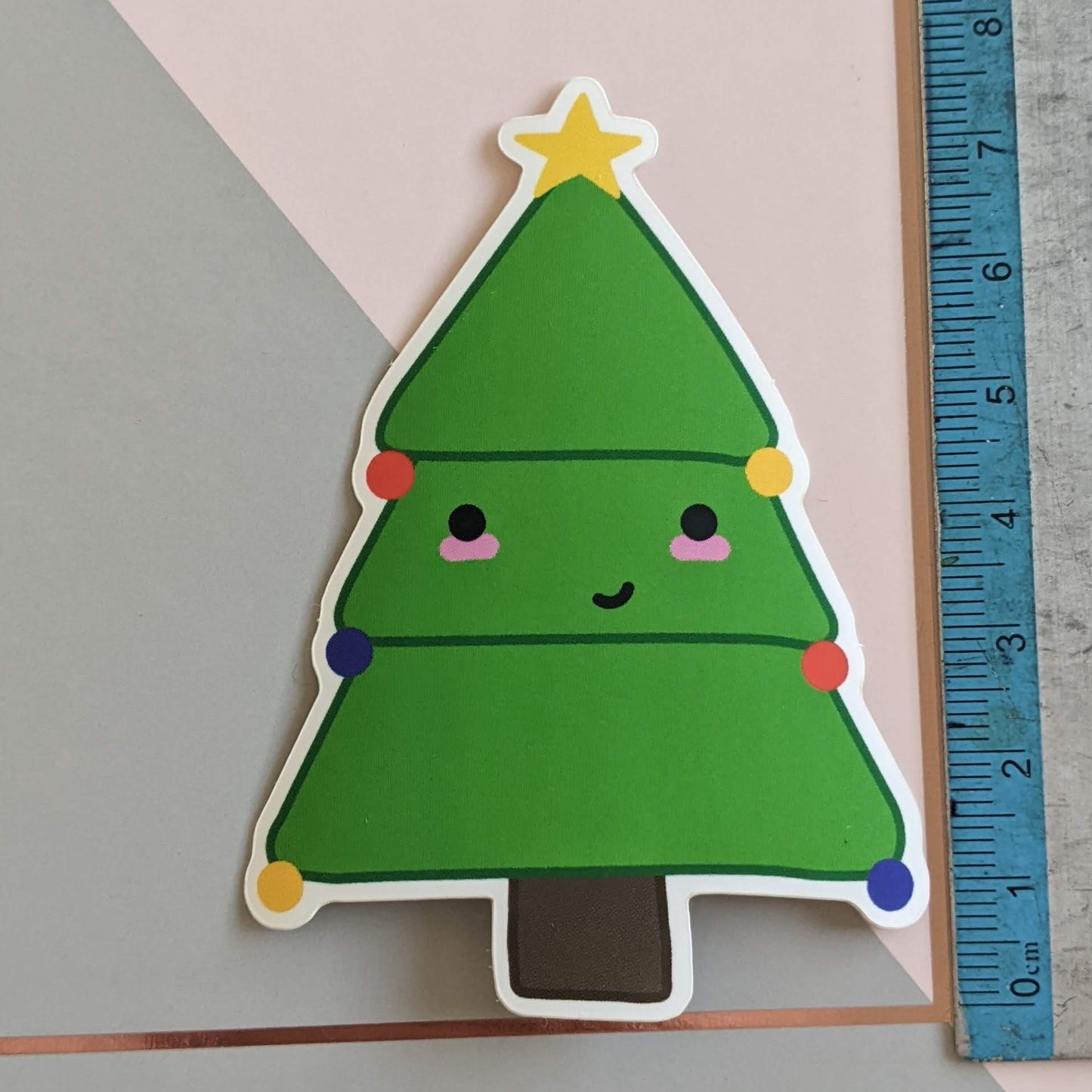 A close up of the Christmas tree sticker with a ruler showing the scale at 7.75cm tall